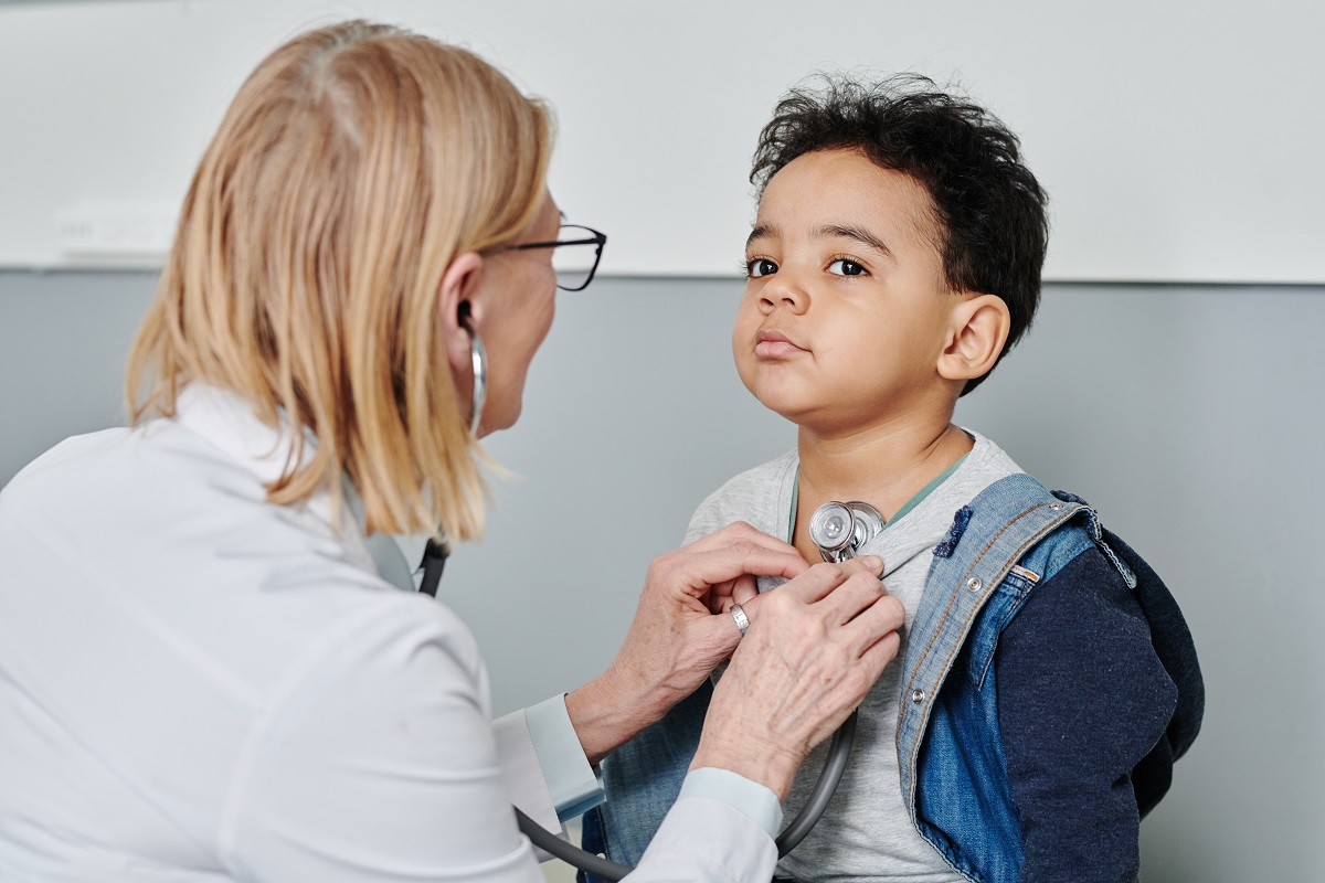 cute little boy having medical treatment during visit pediatrician in hospital