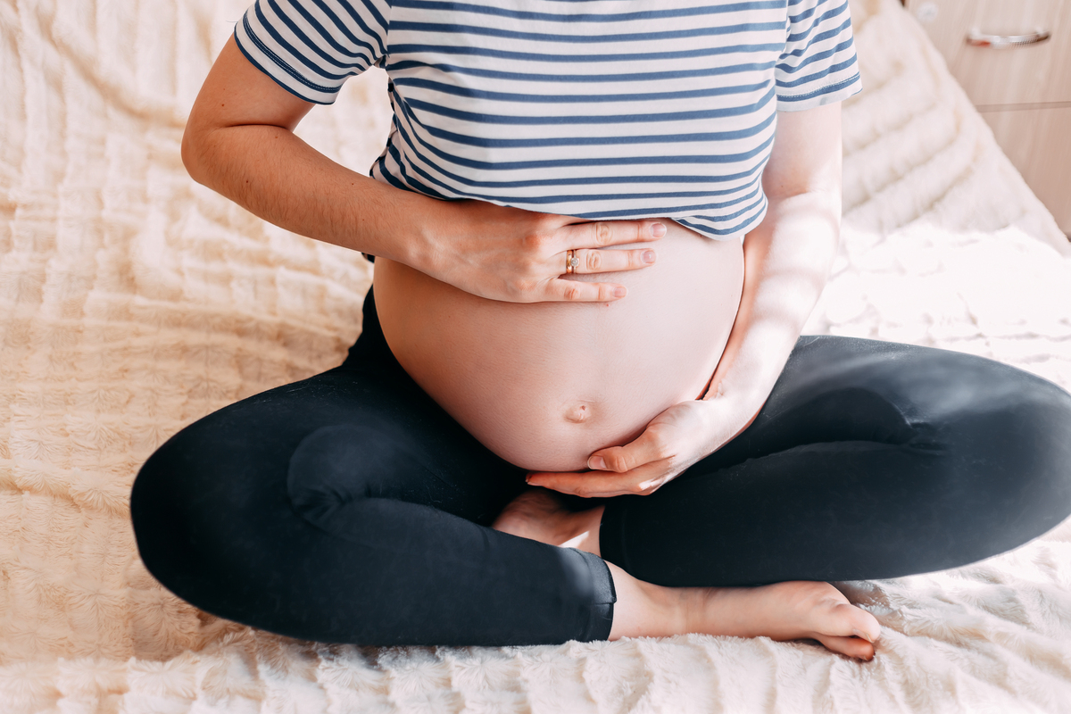 pregnant woman belly. pregnancy concept. in living room. pregnant tummy close up