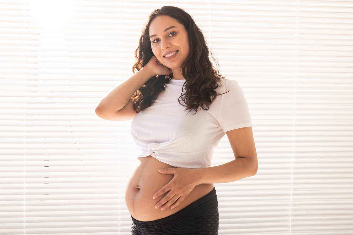 pregnant woman touching her belly, copy space. pregnancy and maternity leave