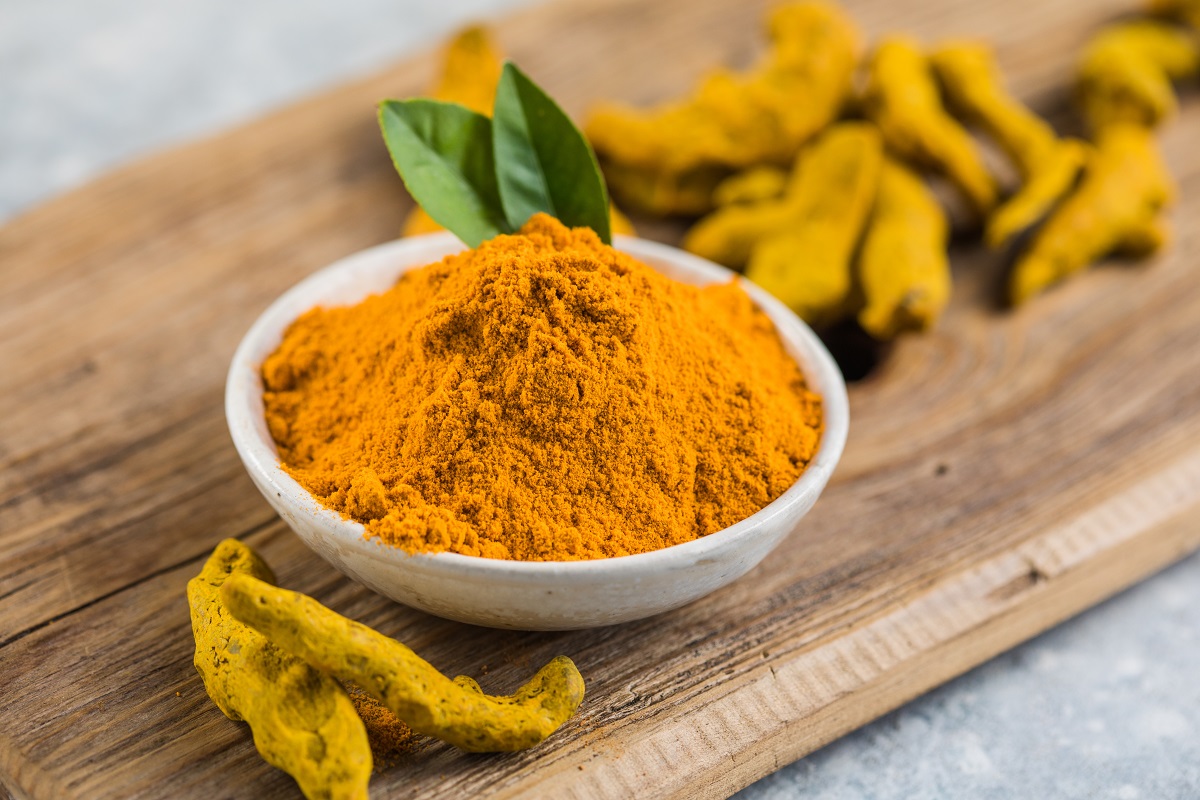 indian turmeric powder and root. turmeric spice.